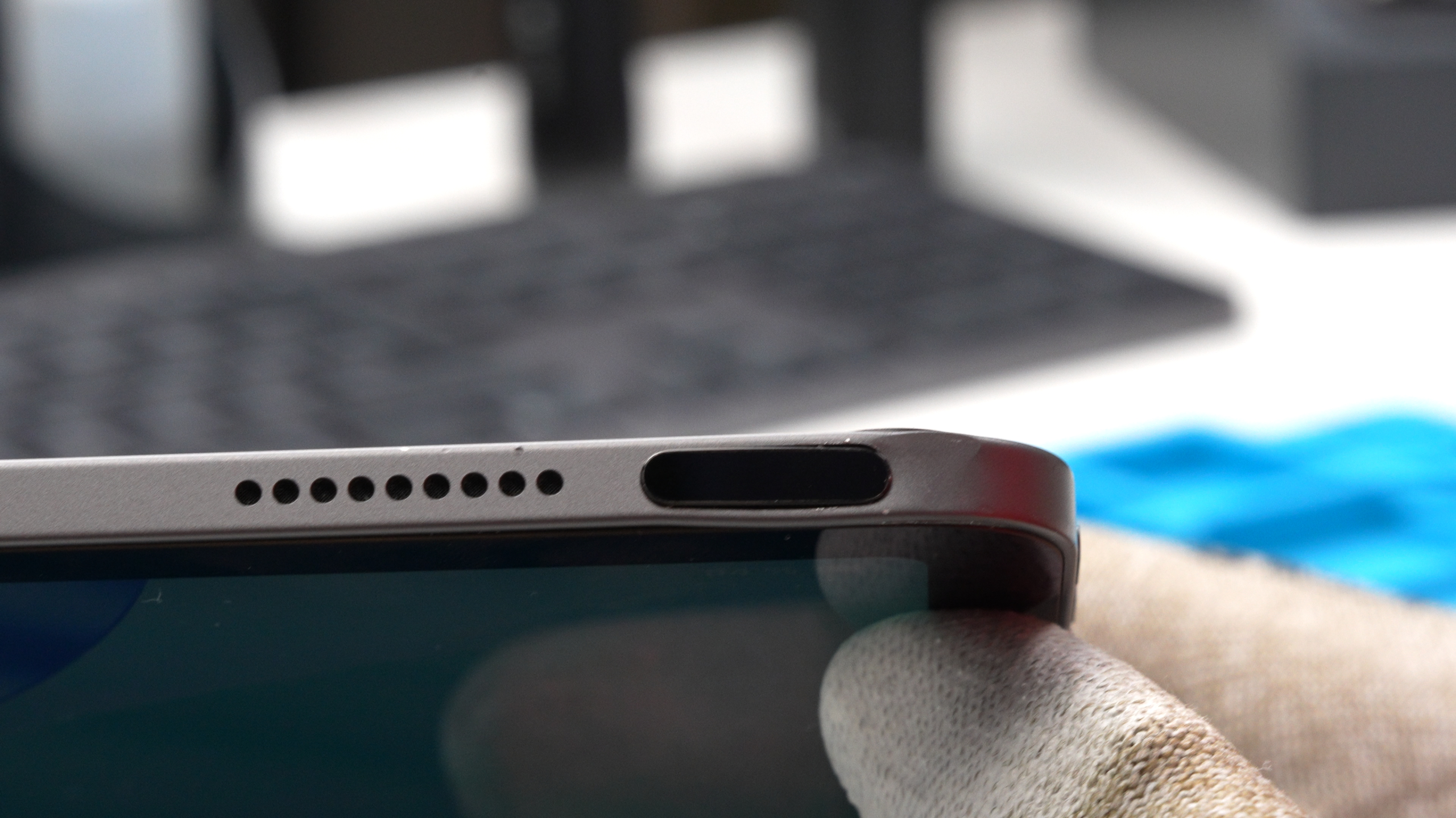 Tablet-Ipad-Reparatur Detailaufnahme eines Tablets in der Werkstatt: Der Powerbutton ist nach einem Sturz oder Schlag sichtlich beschädigt und eingedrückt, was eine Reparatur erforderlich macht.